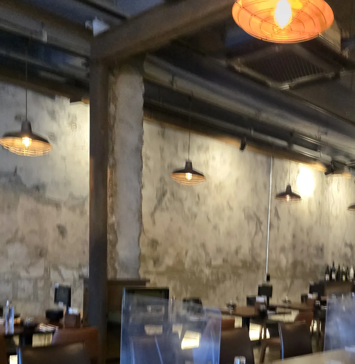 Central Reducer interior — industrial concrete walls and warm pendant lights