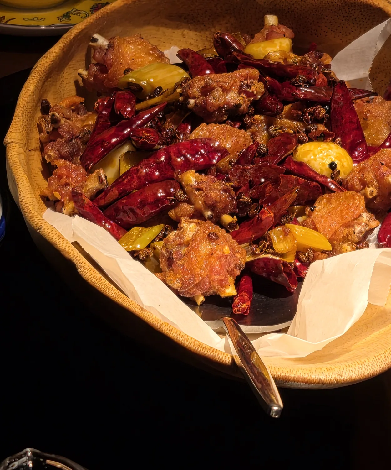Laziji — crispy chicken wings with dried chilies and Sichuan pepper in a bamboo basket