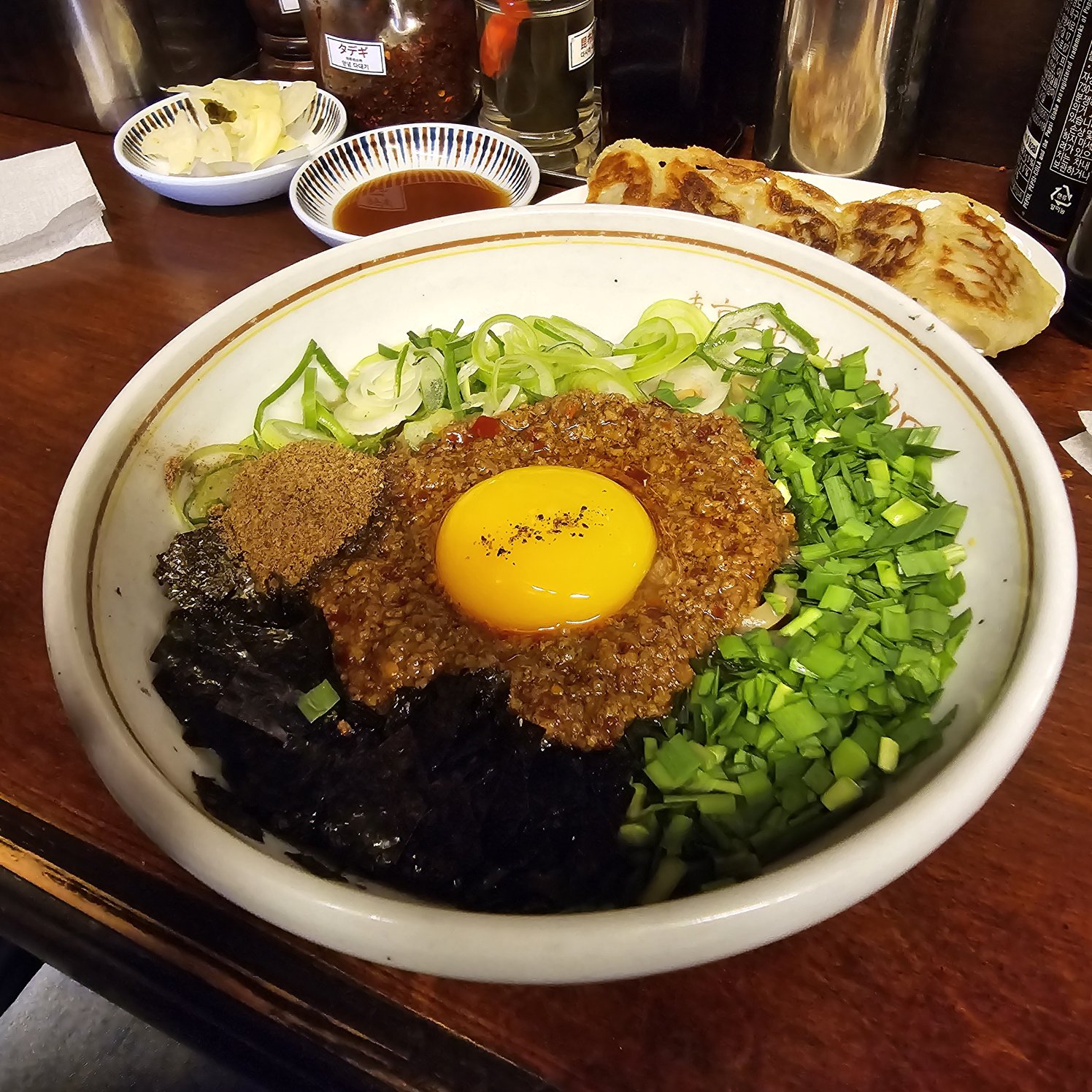 Mazesoba at Kanda Soba topped with raw egg yolk, green onions, seaweed, and rich meat sauce