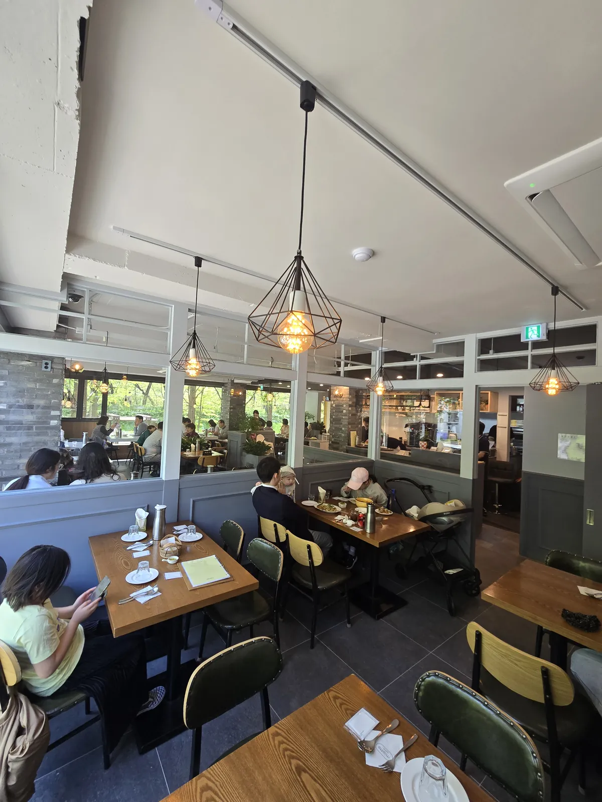 Miette 2F interior — high ceilings, pendant lights, stream views