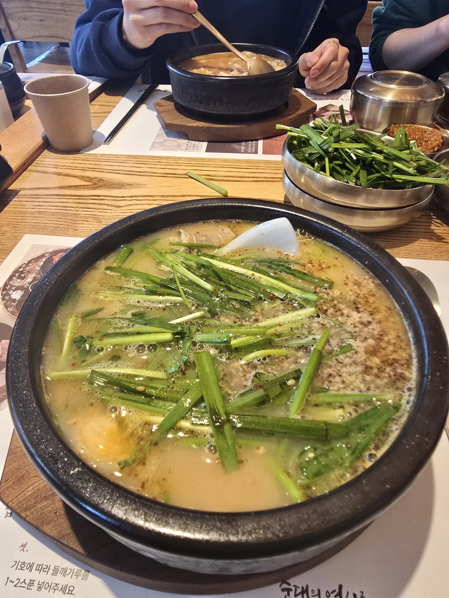 Steaming bowl of sundaeguk topped with fresh chives at Sundae Silrok Seoul — best Korean blood sausage soup
